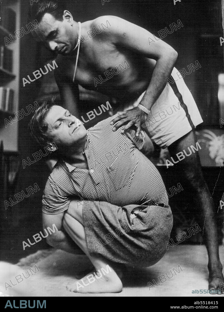 Yehudi Menuhin -- The world famous violin virtuoso is being instructed in yoga exercises. The posture in which he is shown is intended to strengthen the spine by means of circular body movements to left and right. January 05, 1955. (Photo by Camera Press).