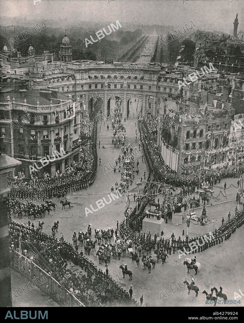Coronation of King George V and Queen Mary, London, 1911. 'Their Majesties' coach seen emerging from Admiralty Arch ready to turn down Whitehall to the Abbey'. Bird's eye view from Trafalgar Square looking towards Buckingham Palace in the distance. The coronation of King George V of the United Kingdom (1865-1936) and Queen Mary of Teck (1867-1953) took place at Westminster Abbey in London on 22 June 1911. From "The Graphic", coronation number, [27 June 1911].