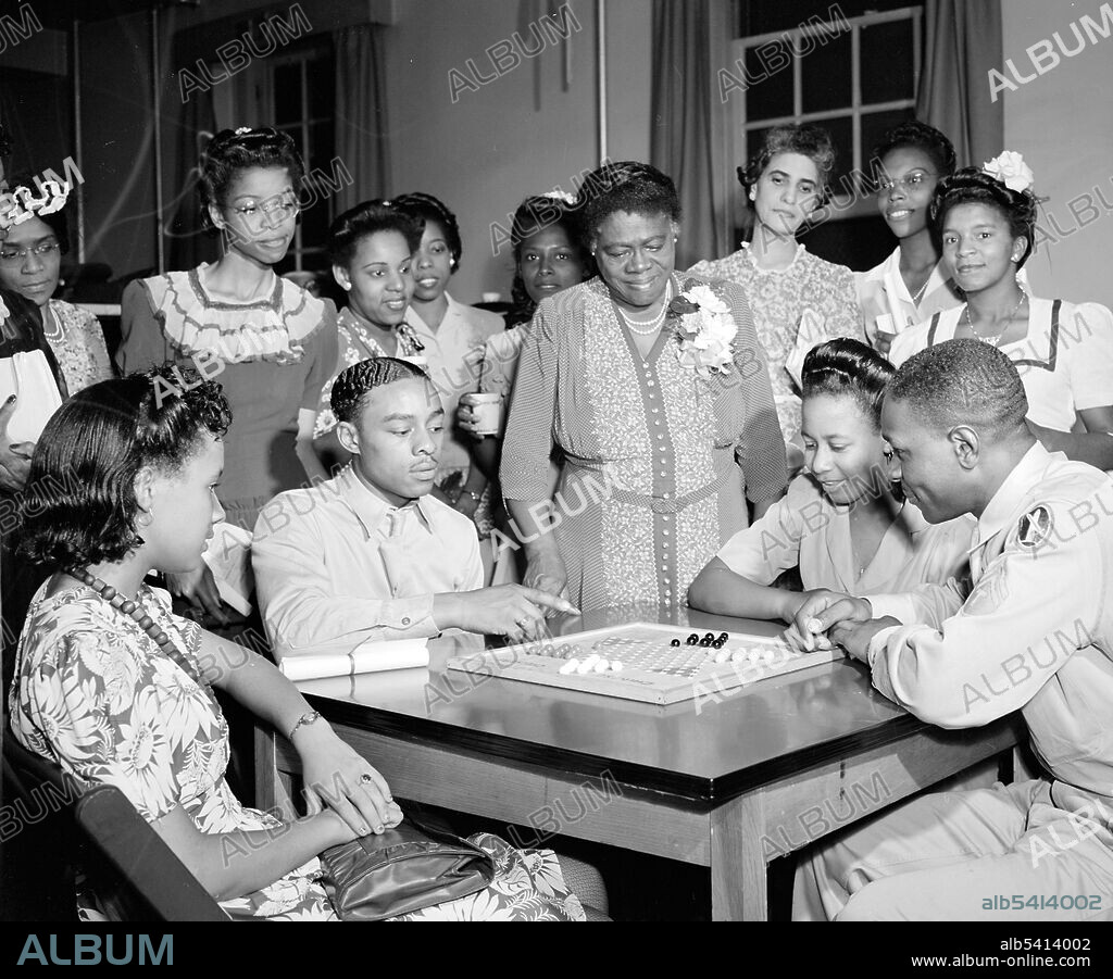 Mary McLeod Bethune at Phyllis Wheatley YWCA (Young Women's Christian Association) on Rhode Island Avenue, Washington D.C. Mary Jane McLeod Bethune (July 10, 1875 - May 18, 1955) was an American educator. With the help of benefactors, she attended college hoping to become a missionary in Africa, but instead started a private school for African-American girl in Daytona Beach, Florida. In 1930, Herbert Hoover appointed her to the White House Conference on Child Health. In 1932, Franklin D. Roosevelt appointed her a national adviser and together they created the Federal Council on Negro Affairs, also known as the Black Cabinet. In 1935, she founded the National Council of Negro Women in NYC. In 1973, she was inducted into the National Women's Hall of Fame. Roger Smith, 1943 (cropped and cleaned).