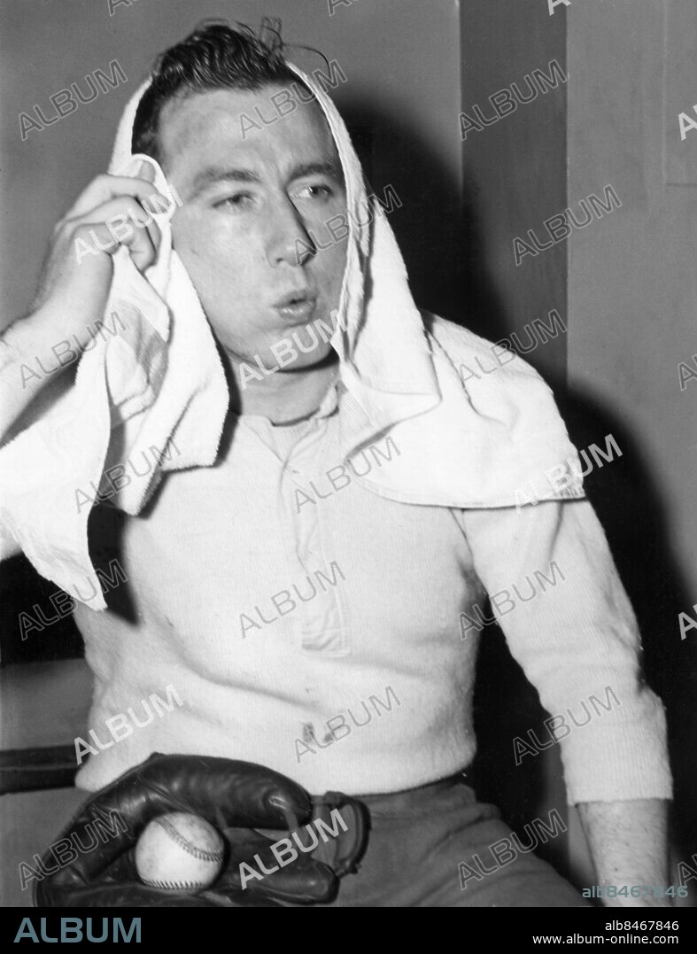 Orig. bildtext... STIRNWEISS-SWEAT Snuffy working out in New York while a Yank holdout - New York. George Snuffy Stirnweiss, last year's speedy second baseman for the New York Yankees, shown at the New York Athletic Club Gymnasium, wiping away the sweat accumulated after a good workout there today, Feb. 16th. Snuffy explained he thought he should have a raise over his 1945 salary but that while he and the club are dickering he expects to peel down to playing weight in the gym. As evidenced by ball and glove in his lap, Snuffy doesn't overlook baseball as a trainer. Meanwhile his successor at second for the Yanks, Joe Gordon, back from service, took part in the Yanks' first practise game in Panama today. 2-16-46 Anm. Baseball Svettig Bollar Handskar Handdukar Pusta CD509 persons: GEORGE SNUFFY STIRNWEISS sites: USA;NEW YORK.
