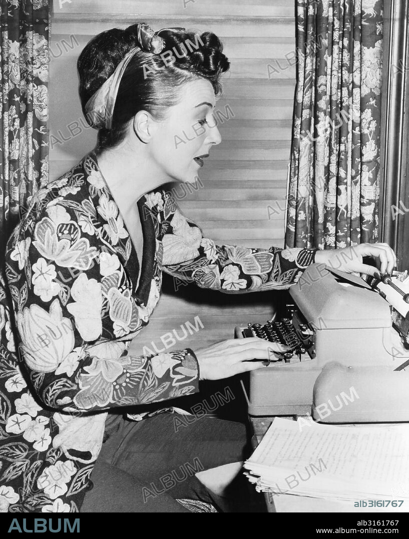 United States: 1956. Burlesque entertainer and actress Gypsy Rose Lee at work on her memoir.