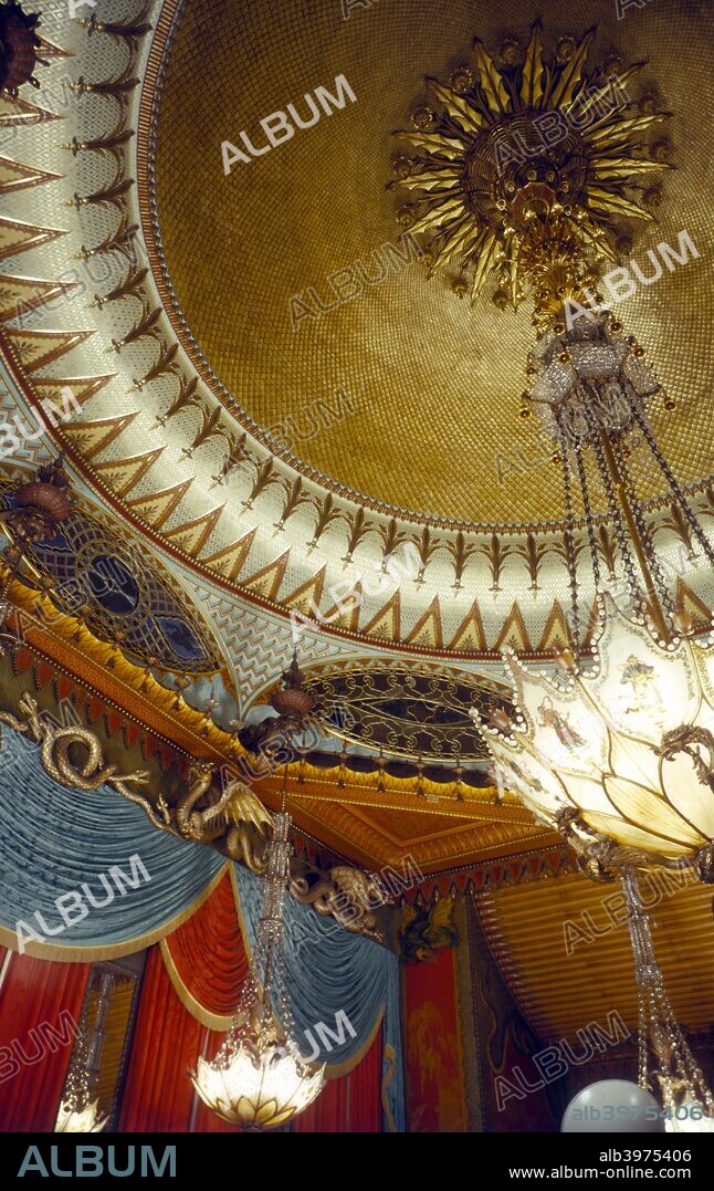 The Music Room, Royal Pavilion, Brighton, East Sussex, 1960s. The Pavilion was originally built in 1786-1787 by Henry Holland for King George IV (1762-1830), then Prince Regent. It was added to by William Porden in 1804-1806 and remodelled by John Nash between 1815 and 1822 in a European interpretation of Indian and Chinese architectural styles. The Music Room is decorated in red and gold 'chinoiserie' style with dragons. It was badly damaged by a fire in 1975 but has since been lovingly restored.