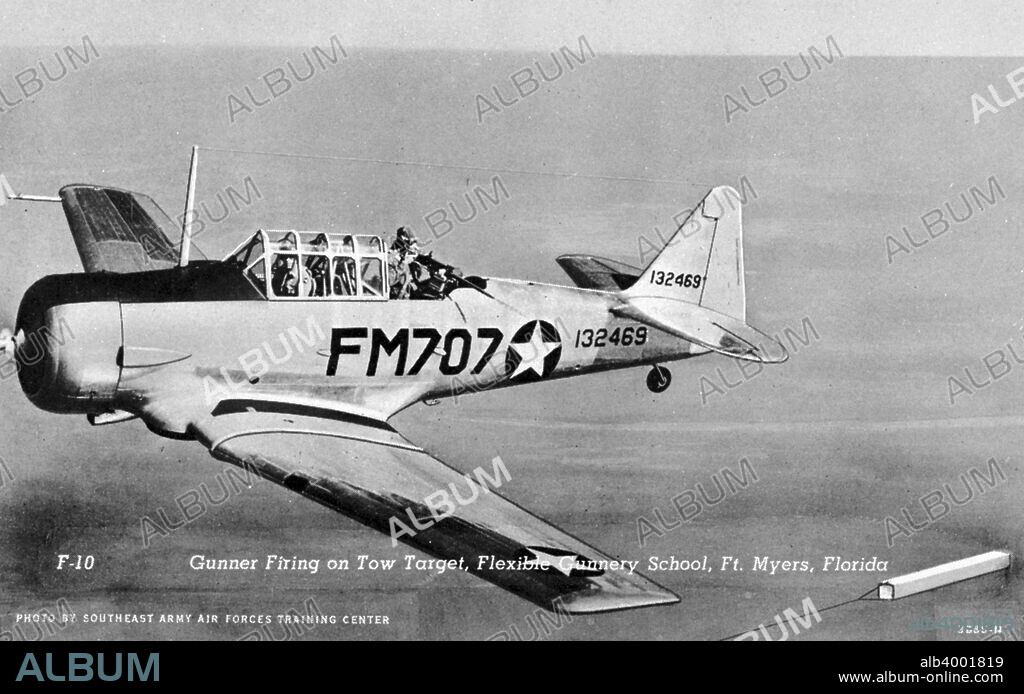 Gunner firing on a tow target, Flexible Gunnery School, Fort Myers, Florida, USA, 1943. Postcard. View of a rear gunner in a plane firing at a tow target with a  mounted automatic weapon.