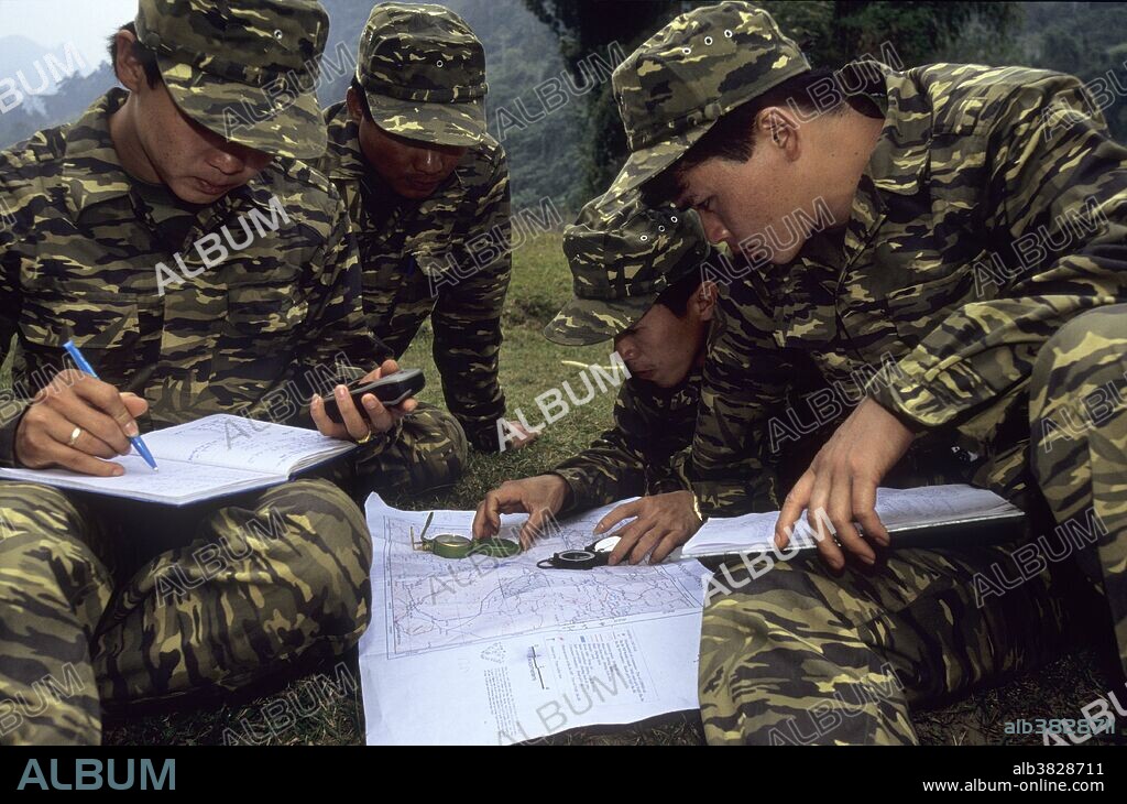 A forest ranger training exercise in Ba Be National Park, Vietnam, as part of a project to build capacity in the Forest Protection Department (RFD). The project is a joint one, organised by the RFD, PARC Project and Fauna and Flora International. The rangers are using handheld Global Positioning Systems (GPS), compasses and maps.