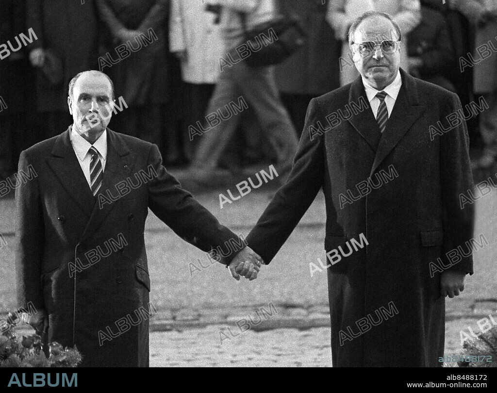 (FILES) - A picture taken on September 22, 1984 on a battlefield in Verdun, eastern France, shows German Chancellor Helmut Kohl (R) and French president Francois Mitterrand holding hands to reaffirm French-German reconciliation, during a ceremony commemorating the victims of the World Wars in Douaumont. France and Germany marked 50 years of reconciliation Sunday but the desecration of German war graves marred a meeting of their leaders that could ease tensions on tackling the euro debt crisis. German Chancellor Angela Merkel and French President Francois Hollande arrived at the Rheims cathedral, a UNESCO world heritage side extensively damaged by German bombing during World War I, for the event on July 8, 2012. AFP PHOTO / MARCEL MOCHET.
