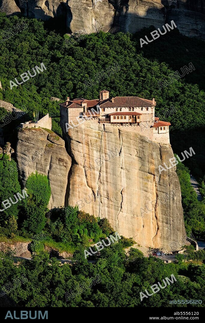 Monastery of Rousanou perched on a cliff in famous greek tourist destination Meteora in Greece on sunset with scenic landscape