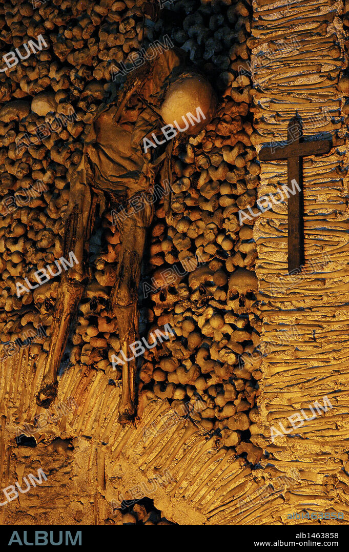 Portugal. Evora. Chapel of Bones. Chapel located next to the entrance of the Church of St. Francis. The interior walls are covered with human skulls and bones.16th century. Skeleton hanging from chains.