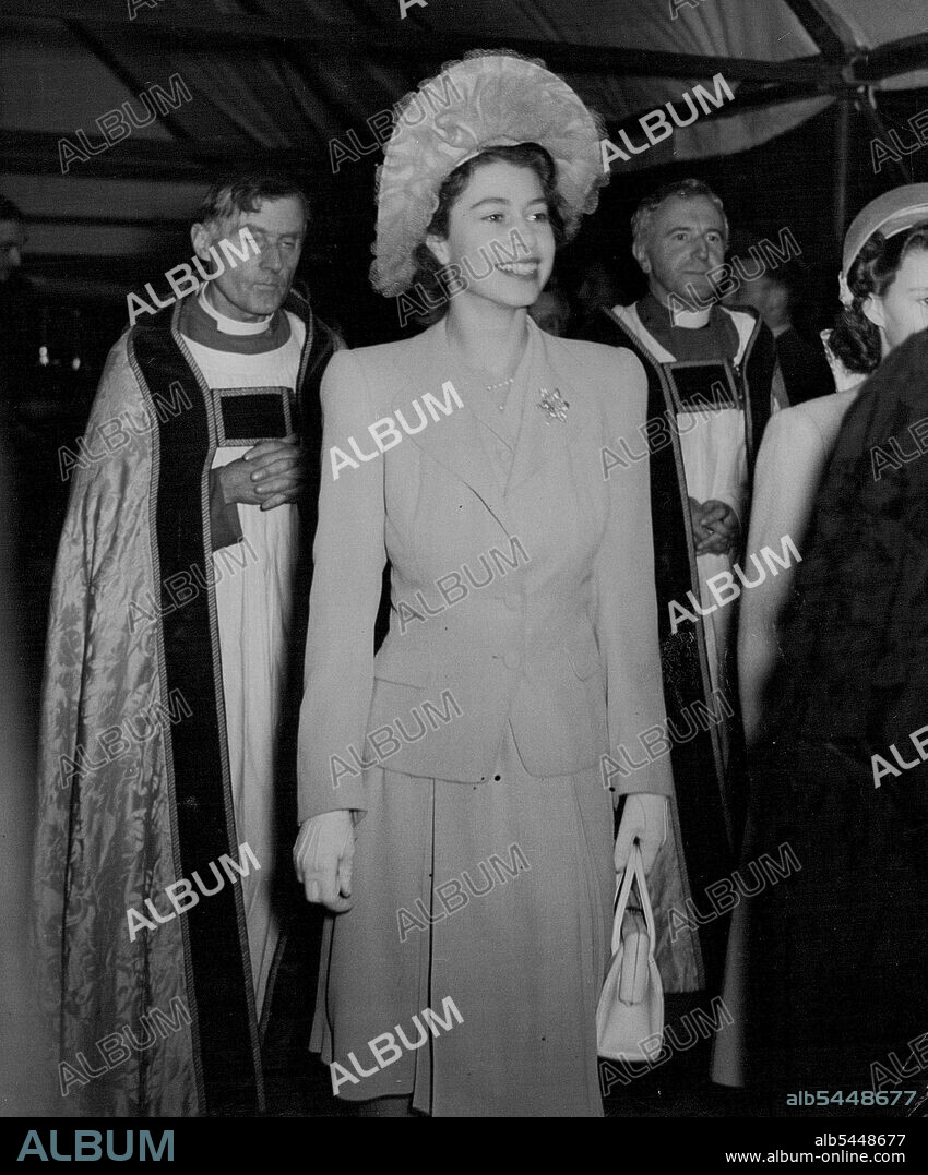 The King Unveils Nation's Tribute to "The Few" - A happy picture of H.R.H. Princess Elizabeth, arriving at Westminster Abbey to the "Battle of Britain" Ceremony to-day (Thursday). Westminster Abbey was to-day (Thursday) packed with relatives of R.A.F. and Fleet Air Arm men who dies in the Battle of Britain for the Memorial Chapel to "The Few" who, by their sacrifice, turned the tide of the war in the dark days of 1940. With the King was the Queen, Queen Marr, Princess Elizabeth, Princess Margaret, the Duke and Duchess of Gloucester, and the Duchess of Kent. Ministers of State and Service chiefs were also present, The Chapel, which includes a beautiful stained-glass window by Hugh Easton, an English walnut alter by Prof. A.E. Richardson RA, sculptured figures by A.F. ***** RA, and a silver cross and ornaments of five chapels forming the chevet of Henry VII's Chapel. Huge crowds waited in the rain to see the Royal Family, with Elizabeth, whose betrothal to Lieut. Phillip Mountbatten, AN.