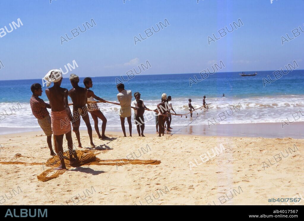 Pulling in Fishing Net from Indian Ocean, Hikkaduwa, West Coast Sri Lanka, 20th century. Local fishermen pull nets from the sea in Sri Lanka, which being an island in the Indian Ocean is ideal for fishing. Hikkaduwa was affected by the tsunami caused by the 2004 Indian Ocean earthquake.