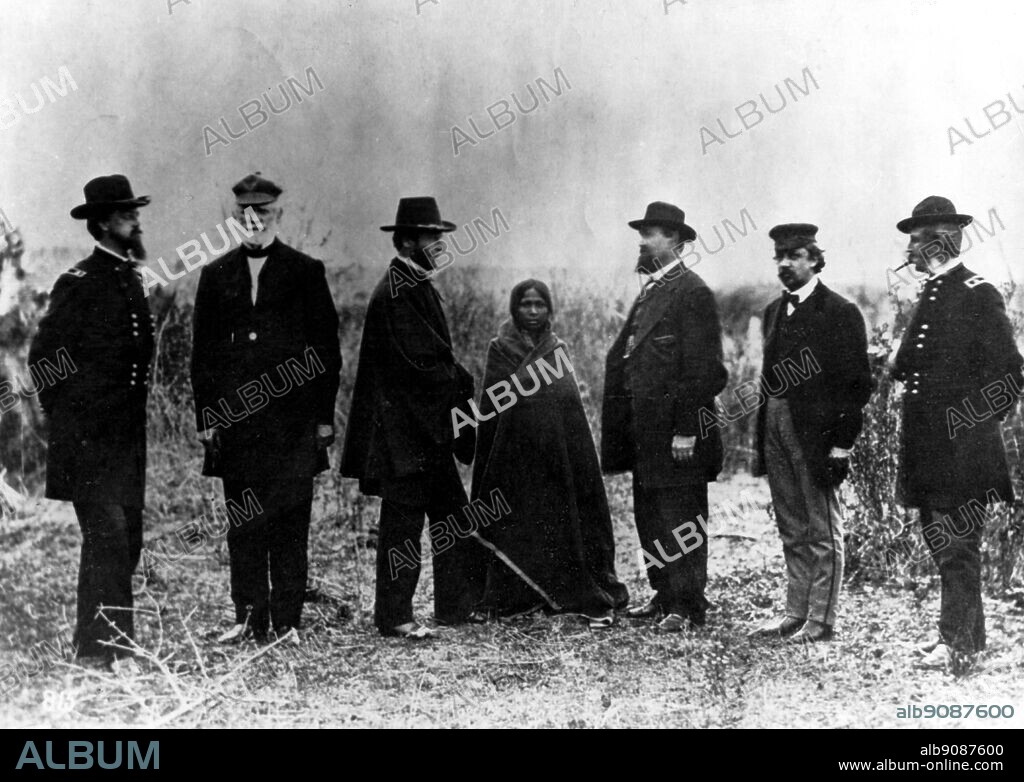 Treaty commissioners - from the left, Terry, Harney, Sherman, Taylor, Tappan, and Auger - pose awkwardly round Sioux woman at Fort Laramie during the talks of 1868.