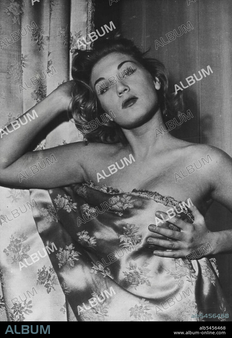 Zina Rachevsky In New Paris Cabaret - Zina Rachevsky, surprised in her flat, takes cover.Zina Rachevsky was just returned from Hollywood where she has made her first film. This was "The Merry Widow" directed by Joe Pasternak. She is now appearing in a new cabaret "La Princesse" that has just opened in the painted cave of "Le Club De Paris". Zina performs songs she has written herself. December 29, 1951. (Photo by Paul Popper, Paul Popper Ltd.).