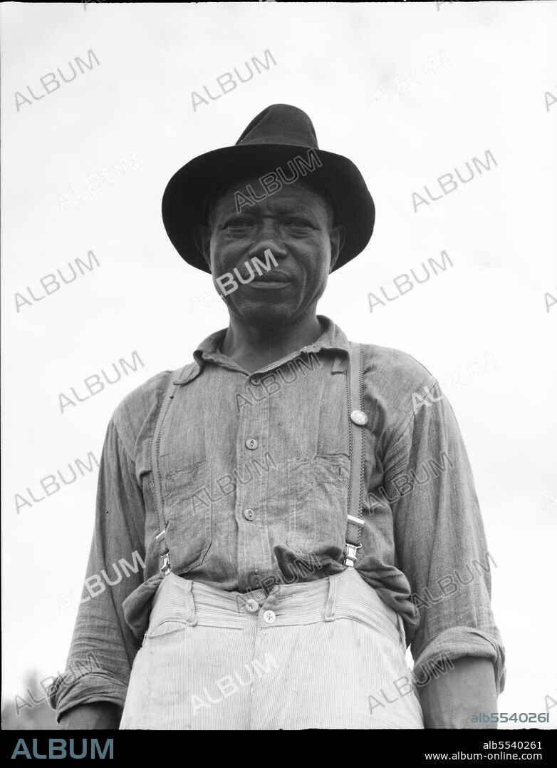 DOROTHEA LANGE. At Hill House, Mississippi. He wears the union button.