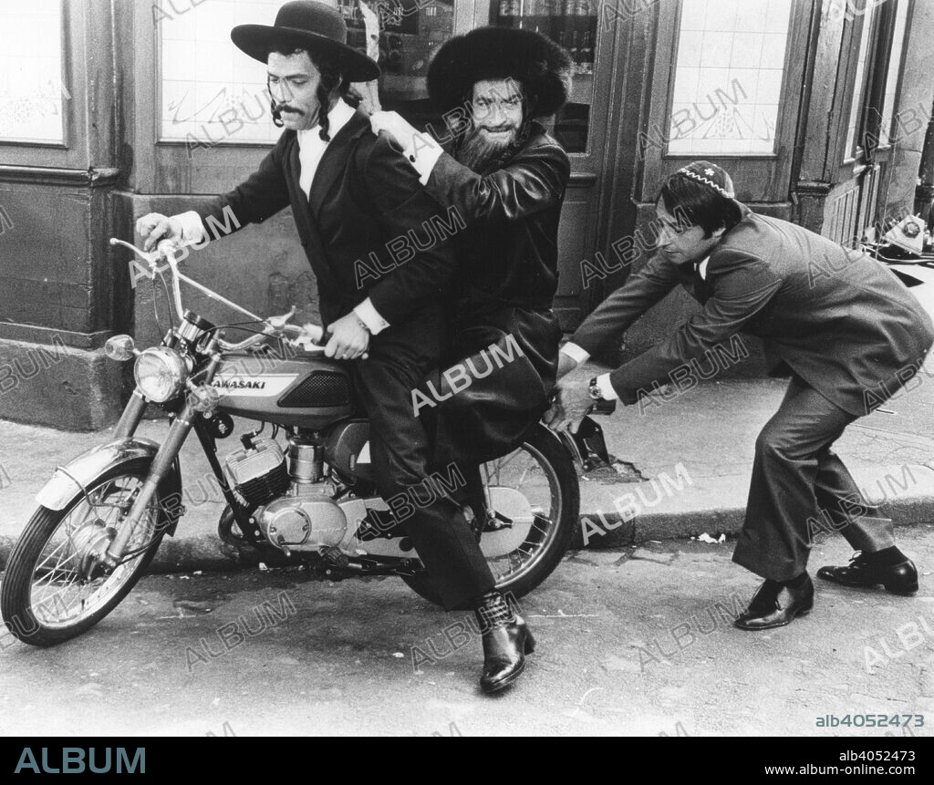 Motorbike chase scene from The Mad Adventures of Rabbi Jacob, 1973. Disguised as rabbis, Victor Pivert (Louis de Funes) and Slimane (Claude Girard) get a push-off from Saloman (Henry Guybet). The film is a comedy about a bigot who, on the day of his daughter's wedding, stumbles across a group of Arab revolutionaries and is forced into hiding as a rabbi. Produced by Bertrand Javal and directed by Gerard Oury from a screenplay by Gerard Oury and Danielle Thompson. Courtesy of 20th Century Fox. For editorial uses only, all other uses to be cleared.