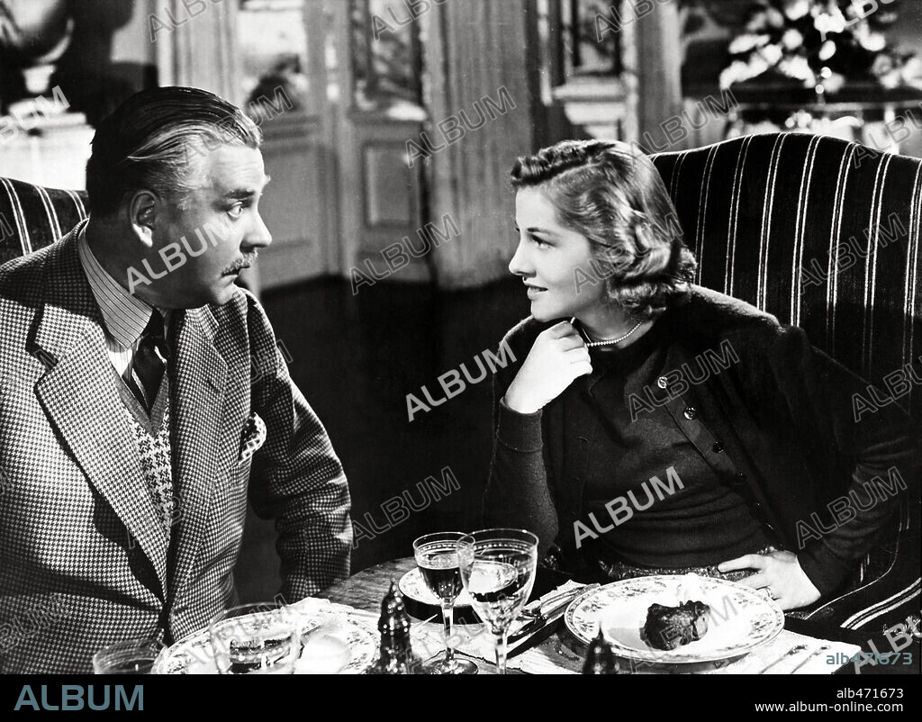 JOAN FONTAINE and NIGEL BRUCE in REBECCA, 1940, directed by ALFRED HITCHCOCK. Copyright Selznick International Pictures.