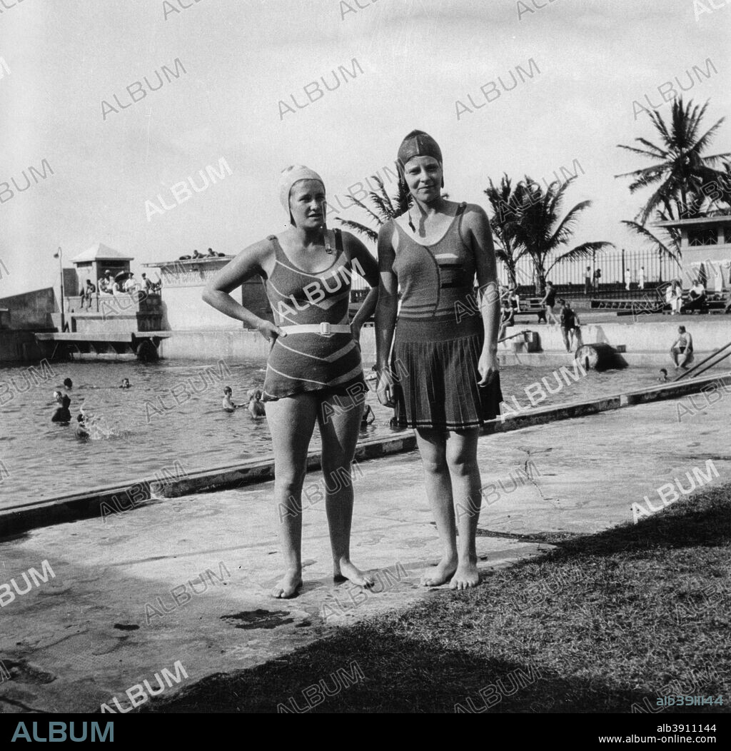 Two women in swimsuits beside a swimming pool, Balboa, Panama, 1931. The photograph was taken during a Cunard Line cruise to the West Indies between January and March 1931.