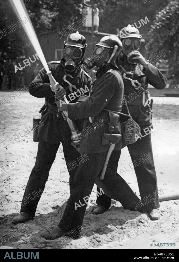 GERMANY BERLIN around 1930. Orig. caption ... GASGEST STRASSE IN BERLIN. Air protection exercise for students at the Technical College. The fire brigade, equipped with gas masks, fights the fire caused by firebombs. Photo: Presse-Photo / AB Text & Bilder / SVT / Code: 5600 Folder: Civil Defense Germany Gas and air protection exercises 4057A Photo series Photo report Fire extinguishing Trio Collaboration sites: BERLIN; GERMANY PhotoDate: 193? - ?? - ??.