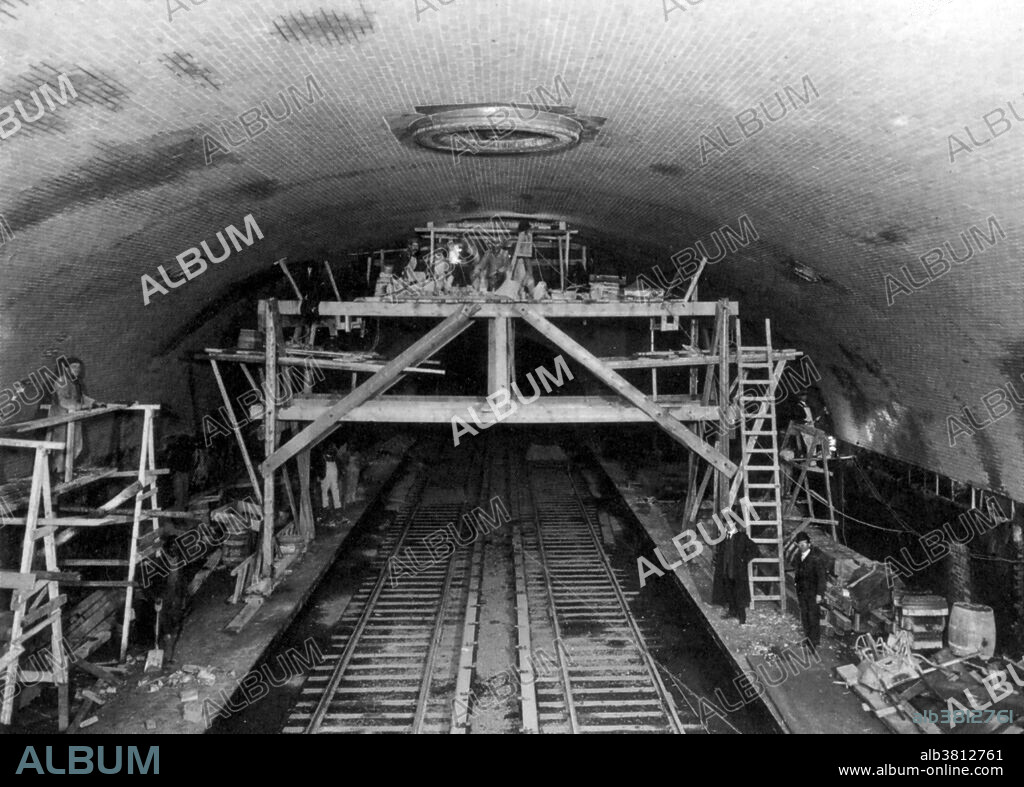 Stop on the original Broadway line at 181st Street under St Nicholas Avenue. Workmen were finishing installation of ceiling lamp fixtures, inspiring some straphangers to call it "Chandelier Station". The IRT Broadway-Seventh Avenue Line is a New York City Subway line. It is one of several lines that serves the A Division (IRT), stretching from South Ferry in Lower Manhattan north to Van Cortlandt Park-242nd Street in Riverdale, Bronx. Operation of the first subway began on October 27, 1904, with the opening of all stations from City Hall to 145th Street on the West Side Branch. Service was extended to 157th Street on November 12, 1904, as the station was delayed because there was still painting and plastering work going on in the station. The West Side Branch was extended northward to a temporary terminus of 221st Street and Broadway on March 12, 1906. The original system as included in Contract 1 was completed on January 14, 1907, when trains started running across the Harlem Ship Canal on the Broadway Bridge to 225th Street. No photographer credited, dated March 1906.