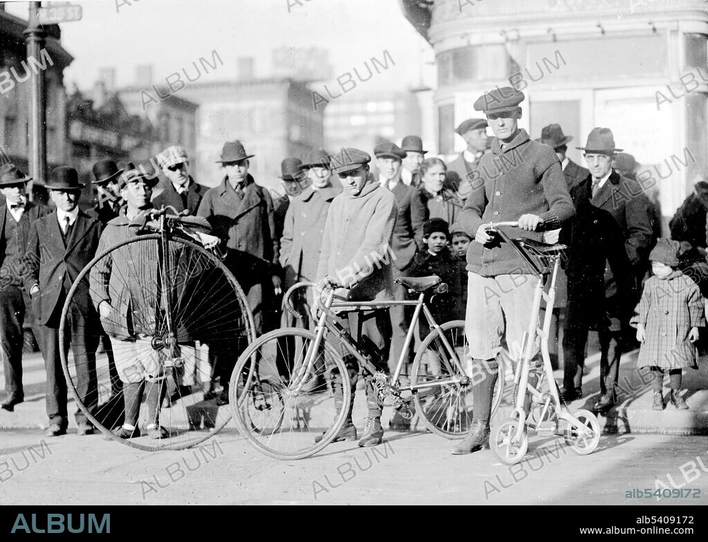 Editorial use only . Men with three types of bicycles. The penny-farthing, also known as a high wheel, and high wheeler, was the first machine to be called a bicycle. It was popular in the 1870s and 1880s, with its large front wheel providing high speeds (large distance for every rotation of the legs) and comfort (shock absorption through the wheel). A bicycle, also called a cycle or bike, is a human-powered, pedal-driven, single-track vehicle, having two wheels attached to a frame, one behind the other. Bicycles were introduced in the late 19th century in Europe, and by the early 21st century, more than 1 billion have been produced worldwide. No photographer credited, December 3, 1919.