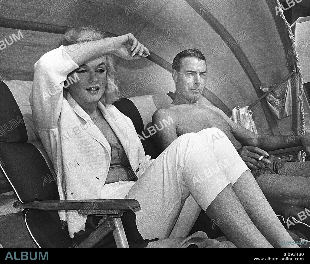 NORMA JEAN BAKER and JOE DIMAGGIO. DRAFT CAPTION 37B Joe DiMaggio, the Yankee Clipper,î and his bride, film star Marilyn Monroe, relax at the Tides Hotel and Bath Club Resort on North Redington Beach in 1961. When the club opened in 1936, it was south Pinellas County's only private club. The resort was demolished in 1996. St. Petersburg Times staff photo by George Swears. 26/07/1999