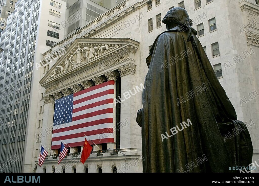 George Washington Monument in front of Federal Hall with a view towards the New York Stock Exchange with an American flag, Wall Street, Financial District, Manhattan, New York City, NYC, New York, United States of America, USA, North America.