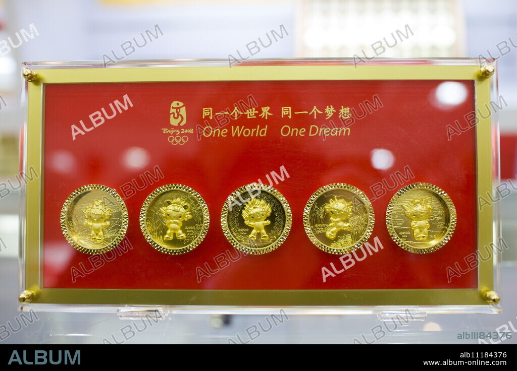 2008 Olympic Games Fuwa mascot characters medallion coins in souvenir shop, Wangfujing Street, Beijing, China.