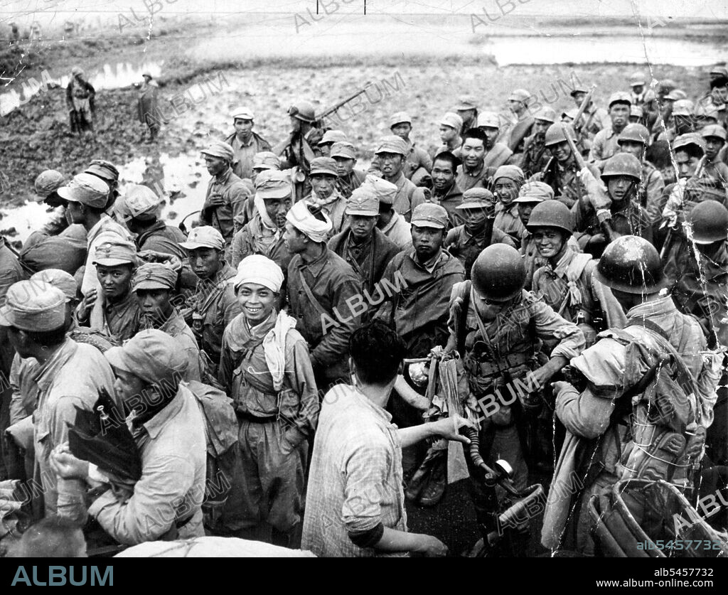 Captives Of Chinese Communists -- Nationalist troops captured in the fighting at Woosung, China, 10 miles North of Shanghai, are herded toward prisoner of war camps by Red guards (wearing helmets). June 17, 1949. (Photo by Associated Press Photo).