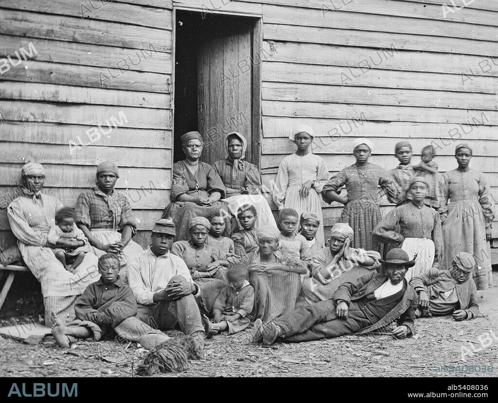 Editorial use only . Contrabands. Group of slaves including men, women and children gathered outside a building at the Foller Plantation in Cumberland Landing, Pamunkey Run, Virginia. Contraband was a term commonly used in the United States military during the American Civil War to describe a new status for certain escaped slaves or those who affiliated with Union forces. The Army (and the United States Congress) determined that the US would not return escaped slaves who went to Union lines and classified them as contraband. They used many as labourers to support Union efforts and soon began to pay them wages. The former slaves set up camps near Union forces, and the Army helped support and educate both adults and children among the refugees. Thousands of men from these camps enlisted in the United States Coloured Troops when recruitment started in 1863. At war's end, more than 100 contraband camps existed in the South. Photographed by James F. Gibson, May 14, 1862.