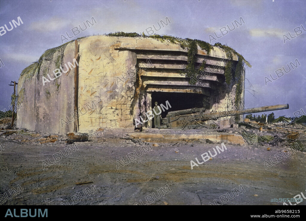 U.S. Soldier Standing at Knocked Out Crisbecq Battery near Utah Beach, Saint-Marcouf, Normandy, France, June 1944.