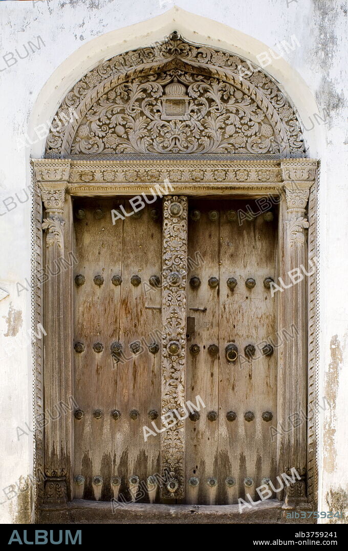 An example of an intricately carved wooden Arab door, Stone Town, UNESCO World Heritage Site, Zanzibar, Tanzania, East Africa, Africa.
