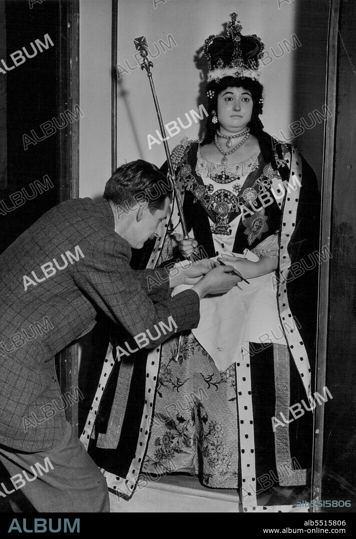 Wax Effigies Return To Westminster Abbey -- Mr. S. Wishart of Madame Tussauds famous wax museum, dresses the effigy of Queen Anne for Monday's opening today.Wax effigies including those of Charles II, Queen Elizabeth, Queen Anne, and Nelson, have been restored to West Minister Abbey from their secret underground war hiding place. May 11, 1951. (Photo by Fox Photos).