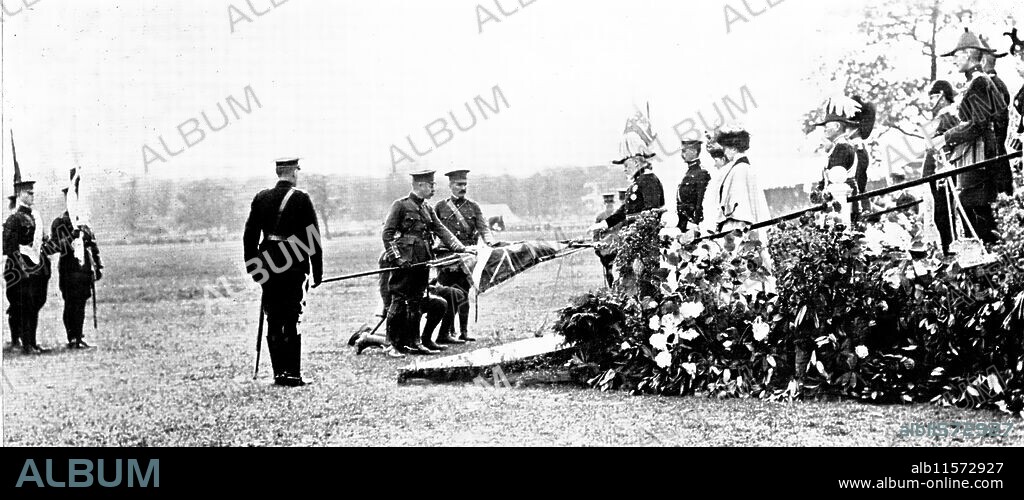TOPICAL PRESS AGENCY. The Royal Review Of 12,000 Territorials in Worsley Park: The Visit Of The King And Queen To Manchester - After The Consecration Of The Colours: The King Touching The Staffs Before The Colours Were Handed Over To The Officers Appointed To Receive Them, 1909. '...his Majesty [King Edward VII] reviewed the East Lancashire Territorial Division, some 12,000 strong, in Worsley Park, which is about six miles west of [Manchester]. On the arrival of the King and Queen, in whose carriage were Mr. Haldane and Lord Derby, the Royal Salute was given and the National Anthem was played. His Majesty then inspected the force. This done, an altar of drums was erected, and the Bishop of Manchester consecrated the colours. These colours were then drooped before the King, who touched them: after that they were handed to the officers appointed to receive them. The march past followed'. From "Illustrated London News", 1909.
