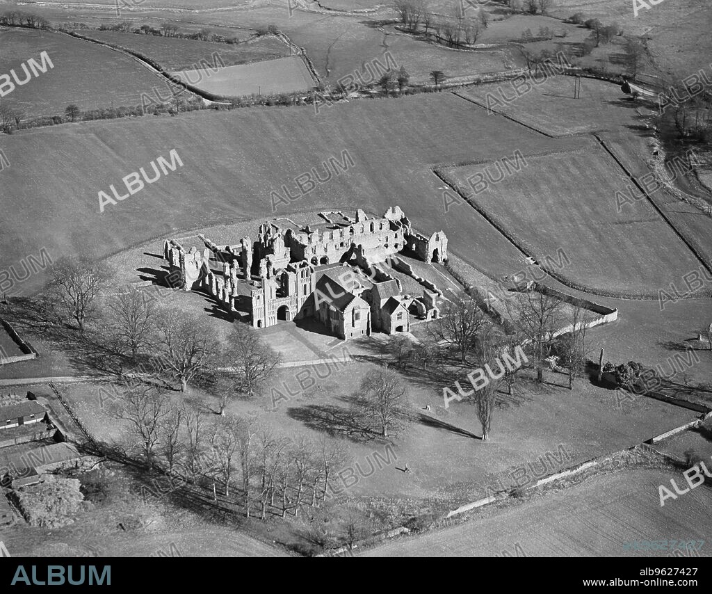 AEROPICTORIAL LTD. Castle Acre Priory, Norfolk, 1946. Aerial view of the Priory ruins. Castle Acre Priory was a Cluniac monastery founded in 1090.