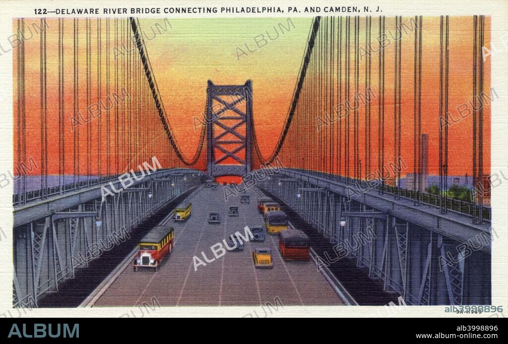 Delaware River Bridge connecting Pennsylvania and New Jersey, USA, 1933. Vintage linen postcard showing the bridge, which links Philadelphia and Camden, at sunset. When completed in 1926, the bridge had the longest span of any suspension bridge in the world. The chief engineer during its construction was Ralph Modjeski. It is now known as the Benjamin Franklin Bridge.
