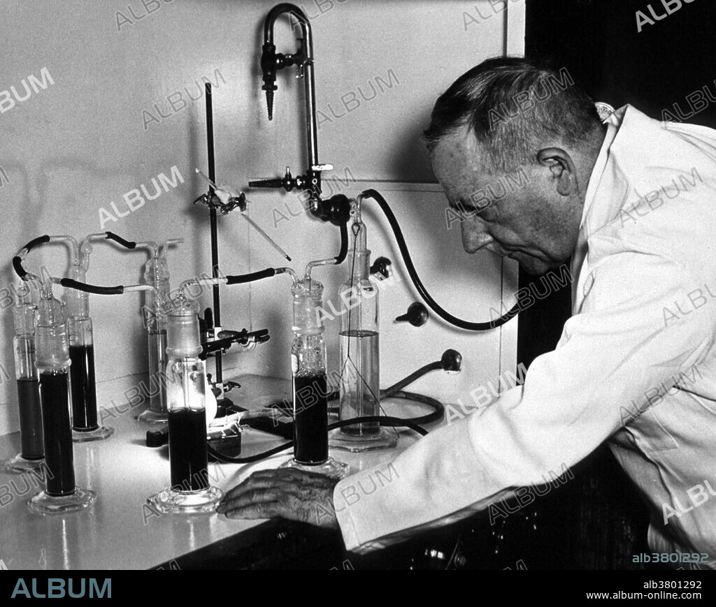 Warburg in laboratory wearing lab cot next to the Warburg manometer used for studying enzyme reactions in which a gas is taken up or given off. No date or location given. Otto Heinrich Warburg (1883-1970) was a German physician and physiologist. He served as an officer in the elite Uhlans (cavalry) on the front during the First World War where he won the Iron Cross. Towards the end of the war Albert Einstein wrote Warburg asking him to leave the army and return to academia. In 1918 Warburg was appointed Professor at the Kaiser Wilhelm Institute for Biology and later named Director of the Kaiser Wilhelm Institute for Cell Physiology. Warburg investigated the metabolism of tumors and the respiration of cells, particularly cancer cells, and in 1931 was awarded the Nobel Prize in Physiology for his "discovery of the nature and mode of action of the respiratory enzyme." In 1944, he was nominated for a second Nobel Prize in Physiology for his work on nicotinamide, the mechanism and enzymes involved in fermentation, and the discovery of flavine, but he did not win. In his later years Warburg was convinced that illness resulted from pollution and became a health advocate. He died in 1970 at the age go 86.