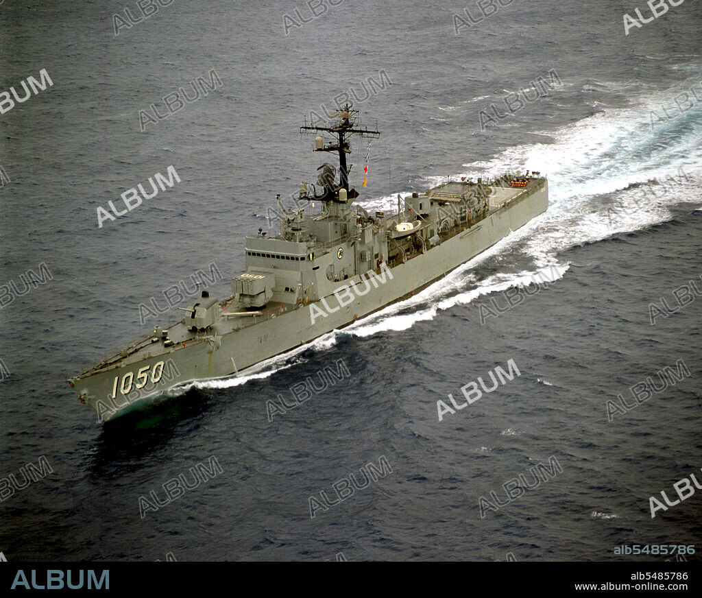 1975- An aerial port bow view of the frigate USS ALBERT DAVID (FF-1050) underway off the Southern California coast.