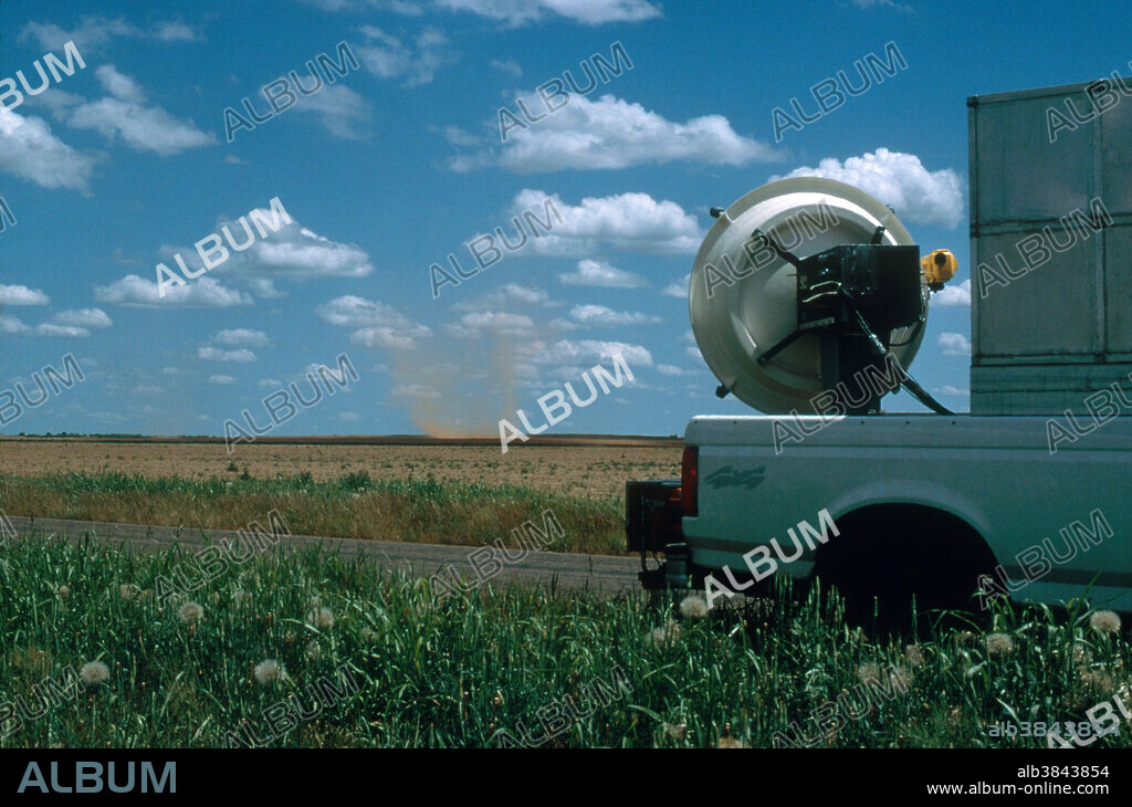 Dust devil (visible in background) being probed by mobile doppler radar.
