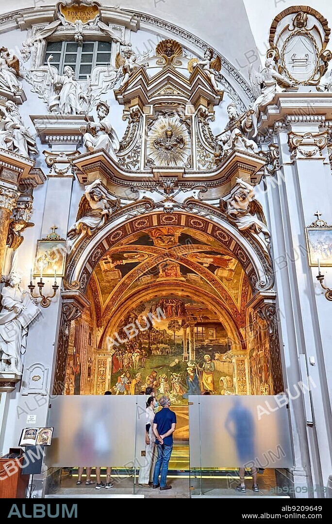 Spello Umbria Italy. Tourists admiring Baglioni Chapel frescoed by Pinturicchio, in Santa Maria Maggiore Church.