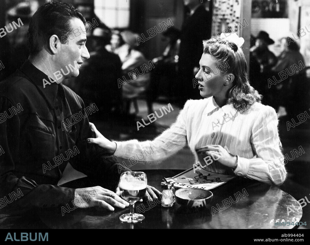 JEAN ARTHUR and JOHN WAYNE in A LADY TAKES A CHANCE, 1943, directed by WILLIAM A. SEITER. Copyright RKO.