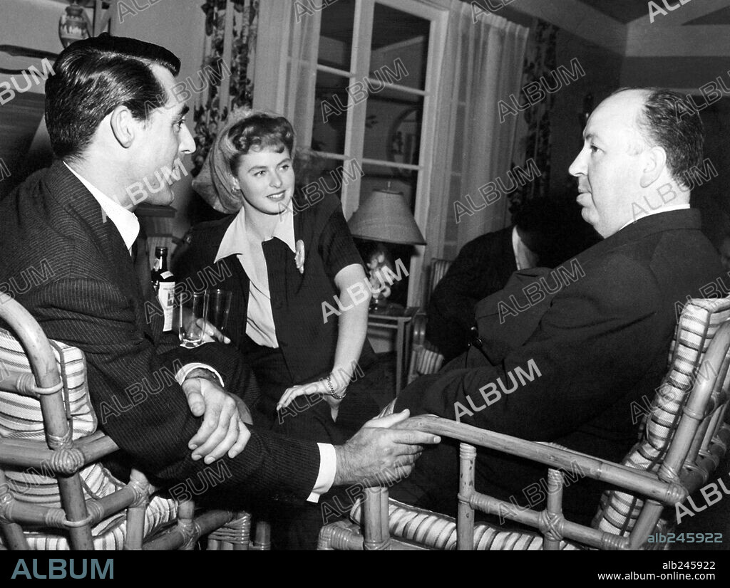 ALFRED HITCHCOCK, CARY GRANT and INGRID BERGMAN in NOTORIOUS, 1946, directed by ALFRED HITCHCOCK. Copyright RKO RADIO PICTURES.