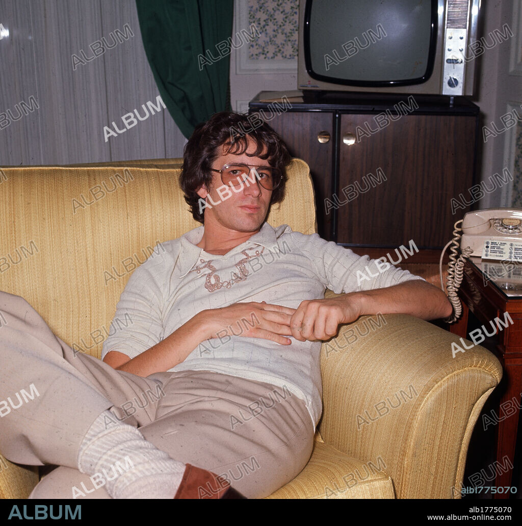 Steven Spielberg on the sofa. The American scriptwriter and movie producer Steven Spielberg sitting on his sofa. 1975.