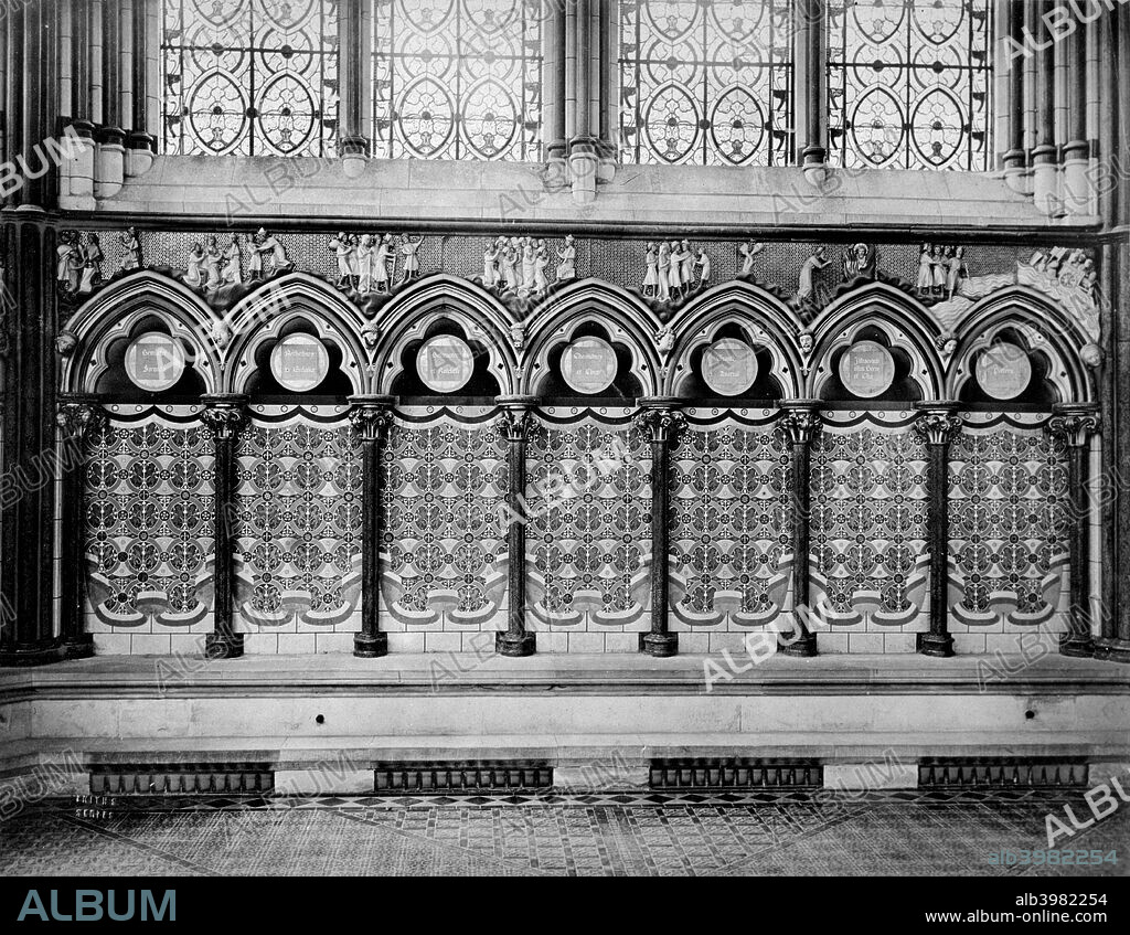Chapter House, Salisbury Cathedral, Salibury, Wiltshire, after 1850s. With an Old Testament frieze depicting Joseph and Moses. The arcade below is painted to resemble curtains in a pattern echoing the glass above, as restored in the 1850s by William Burges, and since removed.