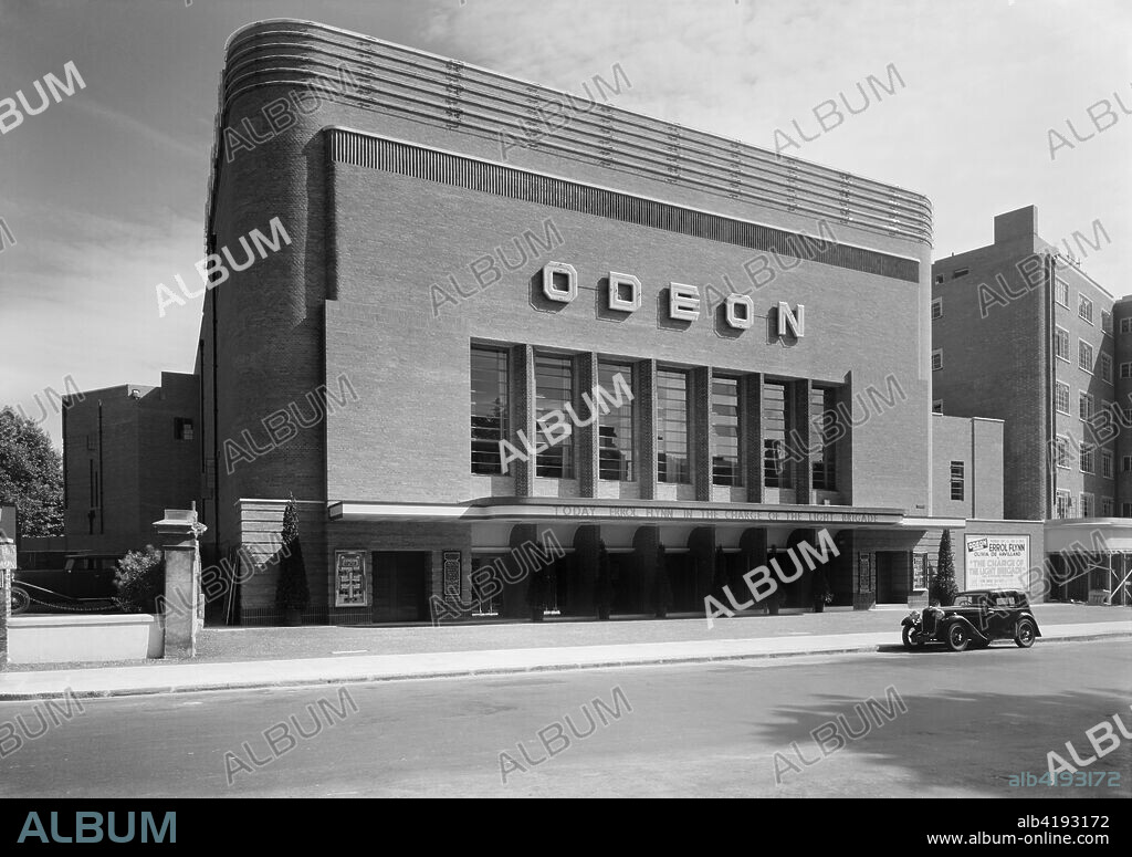 Odeon Cinema, Swiss Cottage, Camden, London, 1937. Oscar Deutsch established the Odeon cinema chain in 1933, and Odeon became a registered trade mark. His cinemas followed a style, embracing the modern movement and Art Deco, and many were new builds designed by Harry Weedon. Weedon and Basil Herring designed the Odeon in Swiss Cottage, which opened in 1937, and is unusual in being of red brick.