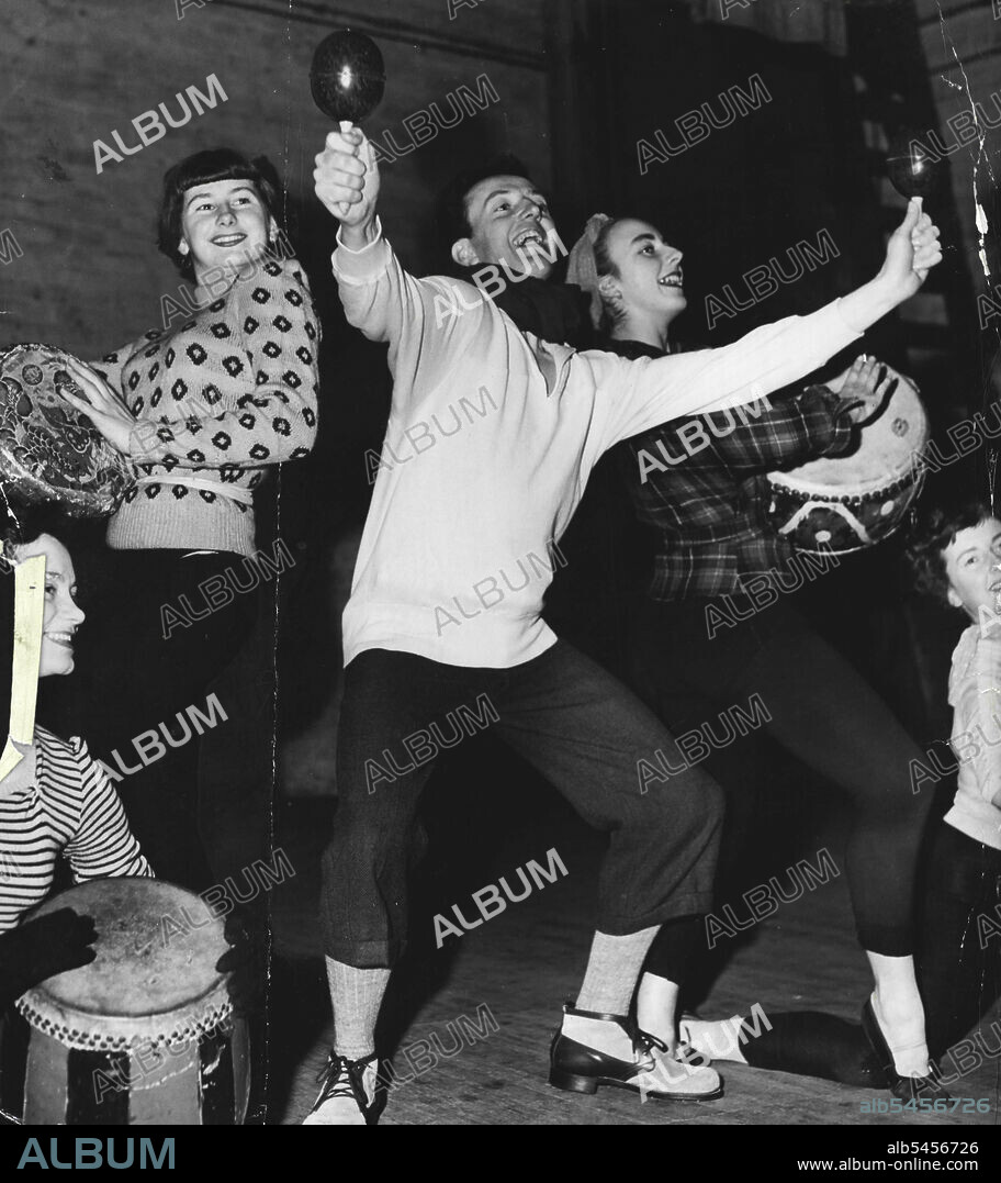 Colorful National Ballet Company's Rex Reid rehearses with ballet girls Marilyn Burr (left) and Marian Ward. June 18, 1950.