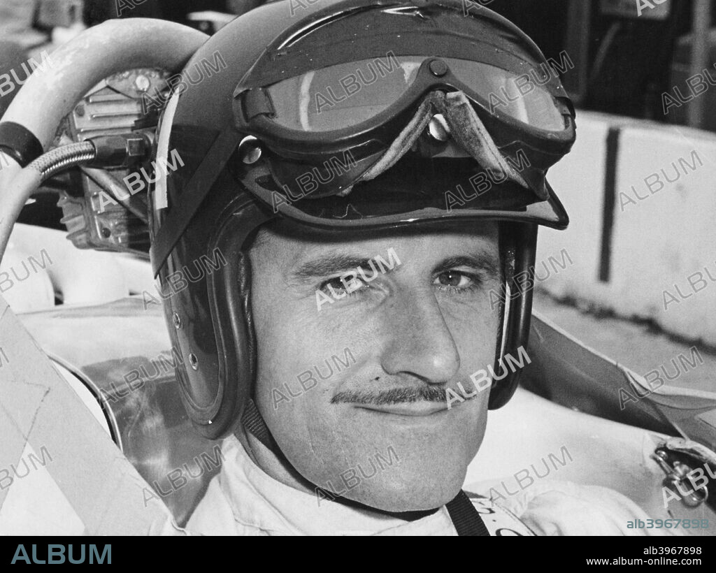 Graham Hill in cockpit of Lola T90, Indianapolis, 1966. Hill won the 1966 Indianapolis 500, his first attept at the race. Graham Hill was one of the first Formula 1 drivers to become a television personality as well as a racing star. He made his debut at Monaco in 1958 and went on to win 14 Grands Prix as well as being Wold Champion twice, in 1962 and 1968. He joined Jim Clark at Team Lotus in 1967, and in 1969 won his last Grand Prix - his fifth triumph at Monaco. He broke both legs when he was flung from his car in the United States Grand Prix, and was killed in a plane crash in 1975 with five other members of his Embassy Hill team.