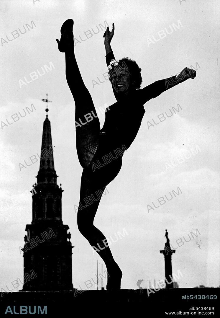 High Neck Gillian Lynne, 25, went dancing yesterday on a roof 122ft. above the streets of London. She was rehearsing at the Colisean Theatre, St. Martin's-lane, for her part in the British production of the American musical how, "Can Can," which is to open at the Coliseum next month. Why dance on the roof" Gillian said; :Because it's warm and funny up here". In the background are the spire of the Church of St. Martin's the Fields and (on right) Nelson's Column. September 22, 1954.;High Neck Gill.