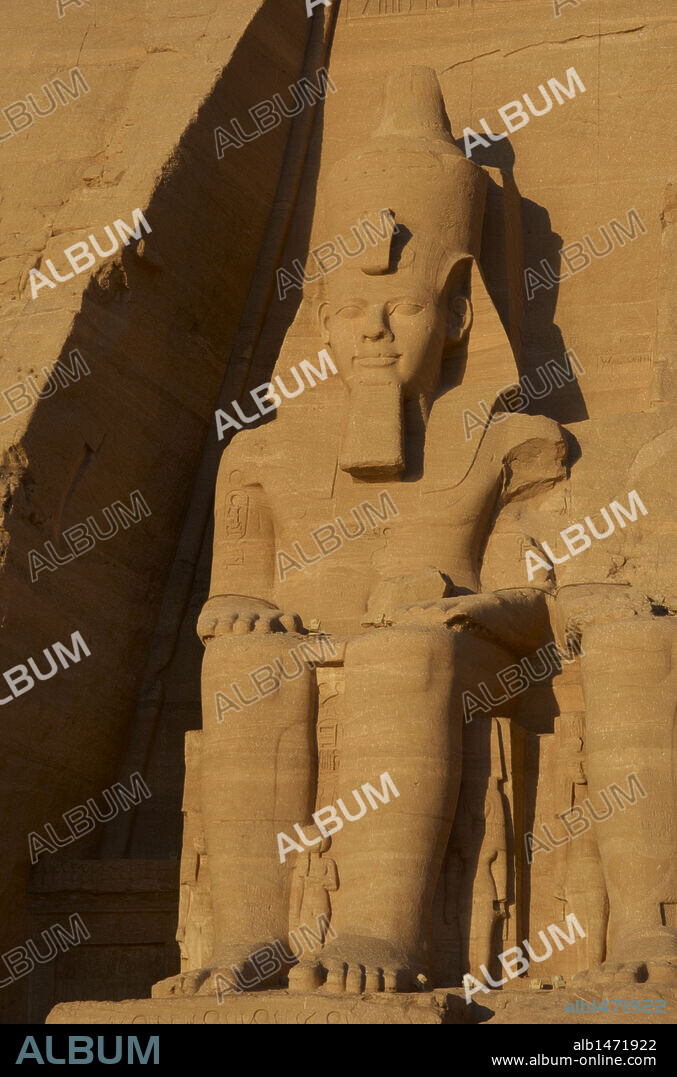 Egyptian art. Great Temple of Ramses II. Colossal statues depicting the pharaoh Ramses II (1290-1224 BC) seated with the nemes head and surmounted by the double crown. 19th Dynasty. New Kingdom. Abu Simbel. Egypt.