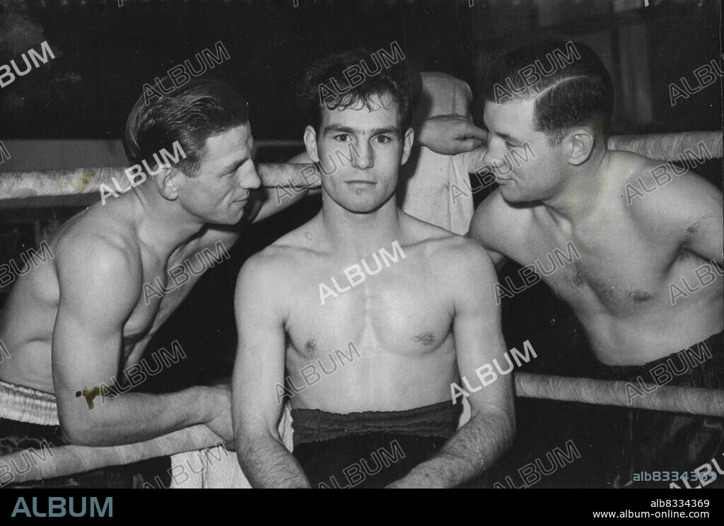 ***** For Mickey From Danny and Dickie - There's nothing like a family conference to steady a fighter in the ring, and Mickey O'Sullivan of Finsbury park, London (centre) apparently appreciates the advice of his two boxing brothers Danny (left) and Dickie, in this picture taken in Jack Solomons' Gym, London. Danny and Mickey are both bantam weights, and Dickie is a flyweight. Although all three are top contenders in their respective classes, Danny is nearest the title mark. He is to fight Ted Gardner for the bantamweight championship of Great Britain at the Albert Hall, London, on  December 13. November 30, 1949. (Photo by Reuterphotos).