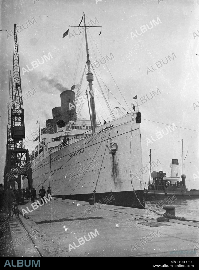 Mauretania to undergo refit not to be scrapped . Picture shows ship docked in port with tug boat alongside. 3 October 1934.