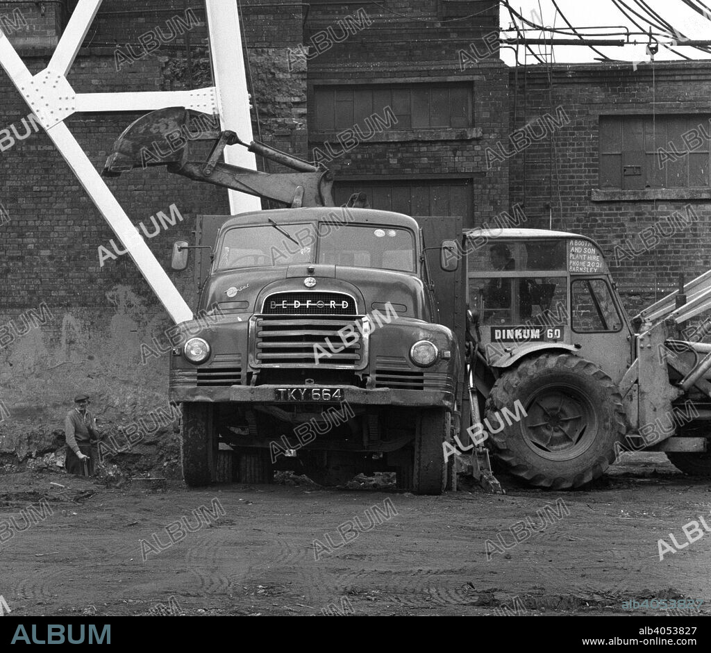 Bedford 7 ton tipper being loaded at Rossington Colliery, near Doncaster, South Yorkshire, 1963. The 6 and 7-ton trucks came with either petrol or diesel engines. All trucks had four speed gearboxes and servo assisted brakes.