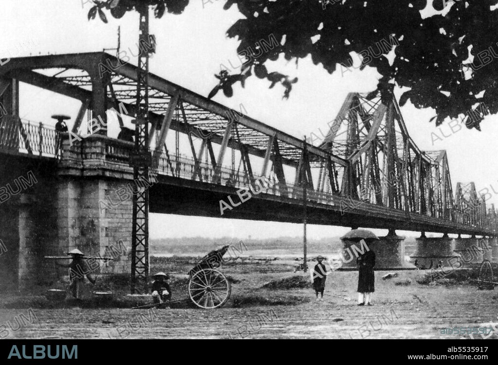 The Long Bien Bridge was erected by the French colonialists between 1899 and 1902 and named the Paul Doumer Bridge in honour of the then Governor of French Indochina (1897–1902). It was designed and built by Dayde and Pille of Paris (the original plaques are still in place) and is 1,682 metres (5,518 ft) long, comprising 18 spans, with an additional lengthened central span of 106 metres (347 ft). It carries the only railway line between Hanoi and Haiphong, as well as two vital rail links with China; until the construction of the new Chuong Duong Bridge in 1985, it also carried the only road traffic across the Red River at Hanoi. The Long Bien Bridge became a major target – perhaps the major target – of the United States Air Force during the Second Indochina War. At the height of the US bombing offensive it was defended by more than 150 Soviet-supplied SAM missiles, as well as massed batteries of anti-aircraft guns. Although hit on numerous occasions, Vietnamese sapper teams working 24 hours a day generally managed to repair the bridge and restore communications within a remarkably short period of time.
